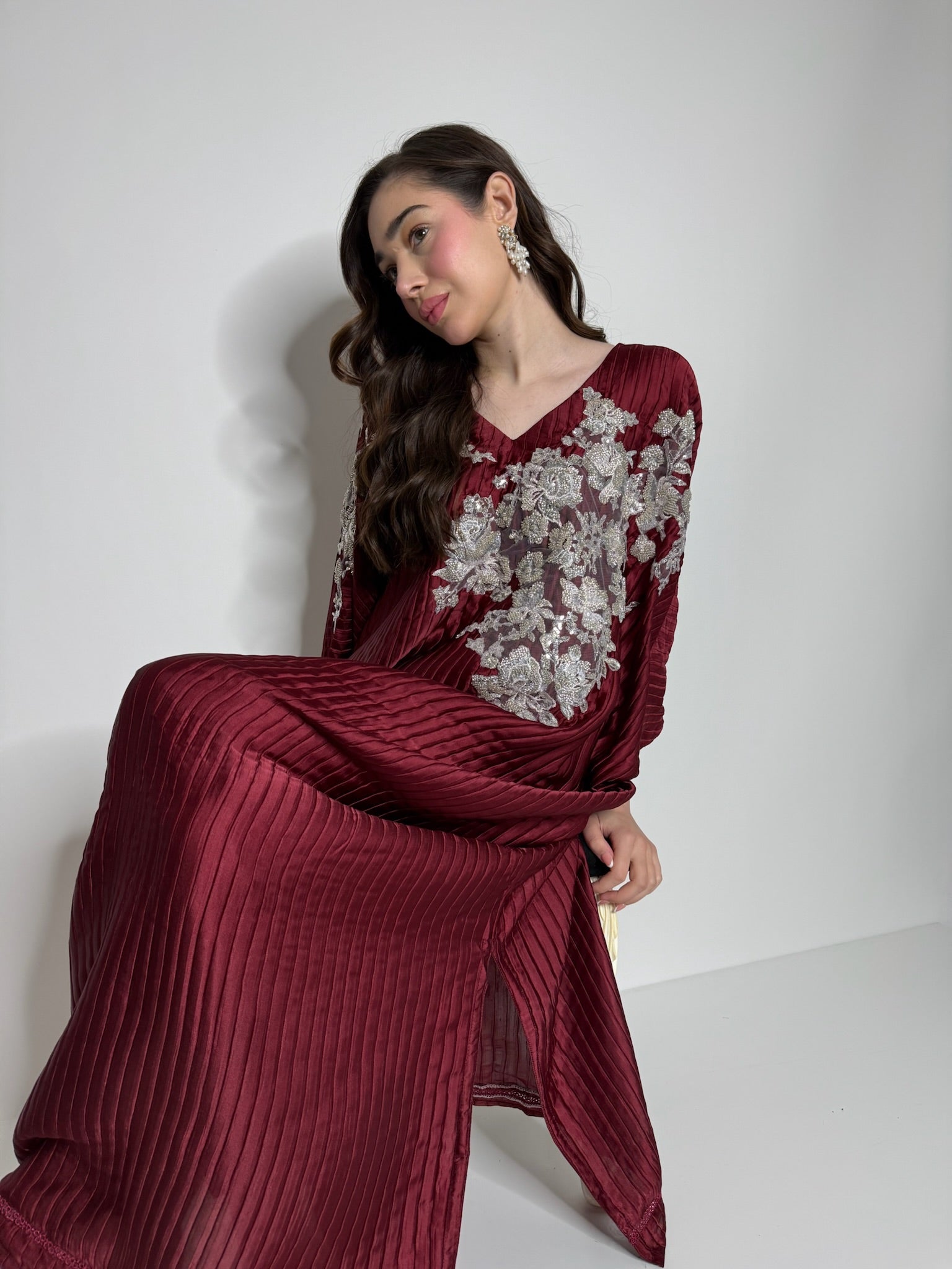 Close up of plissé fabric texture on luxury kaftan, soft pleated finish for elegant modest styling