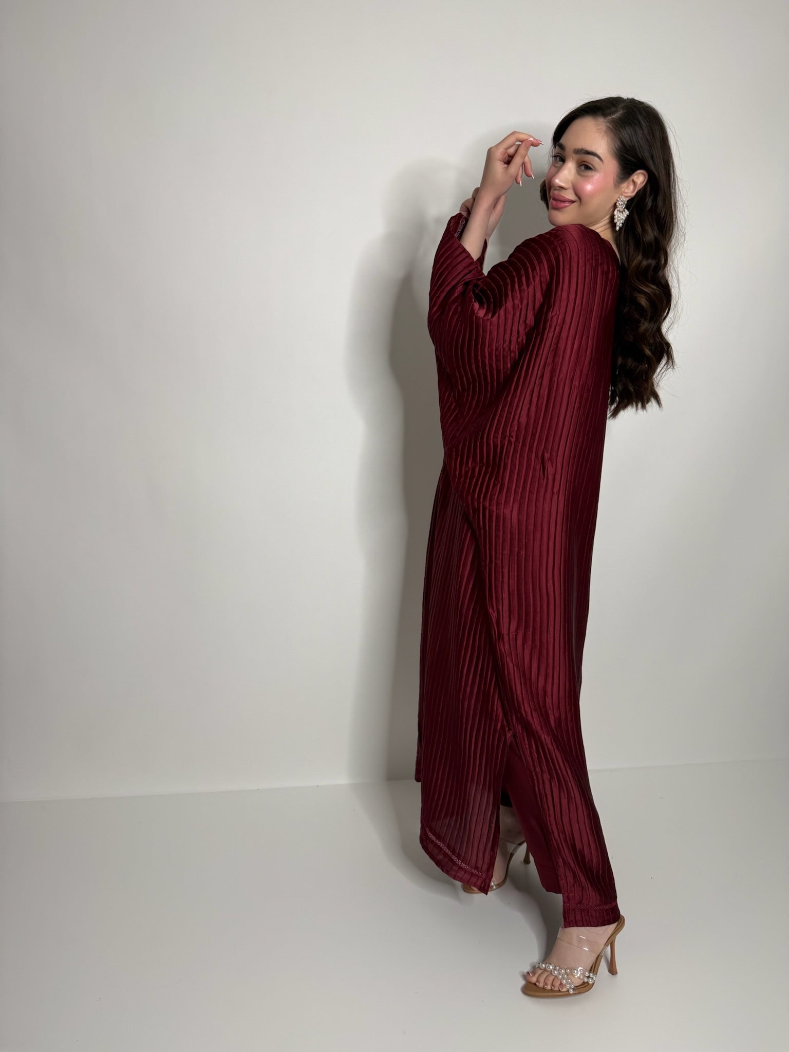 Side profile of flowing plissé kaftan set showing relaxed fit and elegant drape for modest occasionwear.