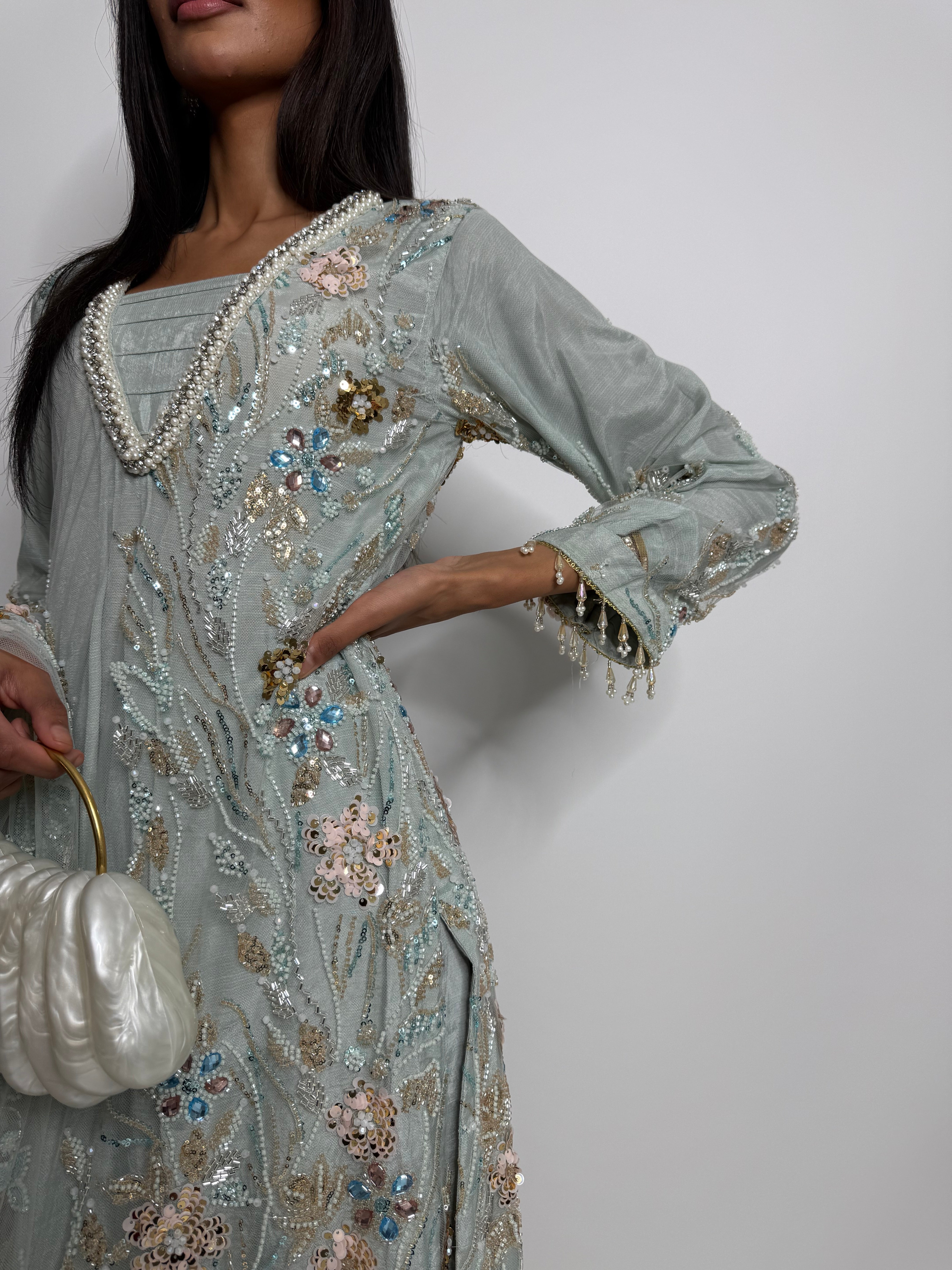 Statement neckline with pearl detailing on mint cutdana embroidered kameez.