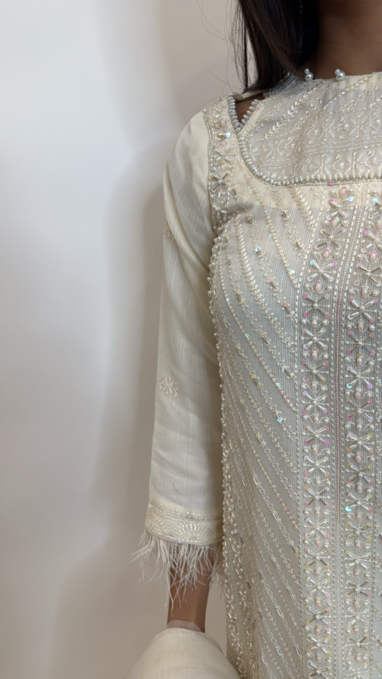 Embroidered front detail on khaki net three piece kameez set.