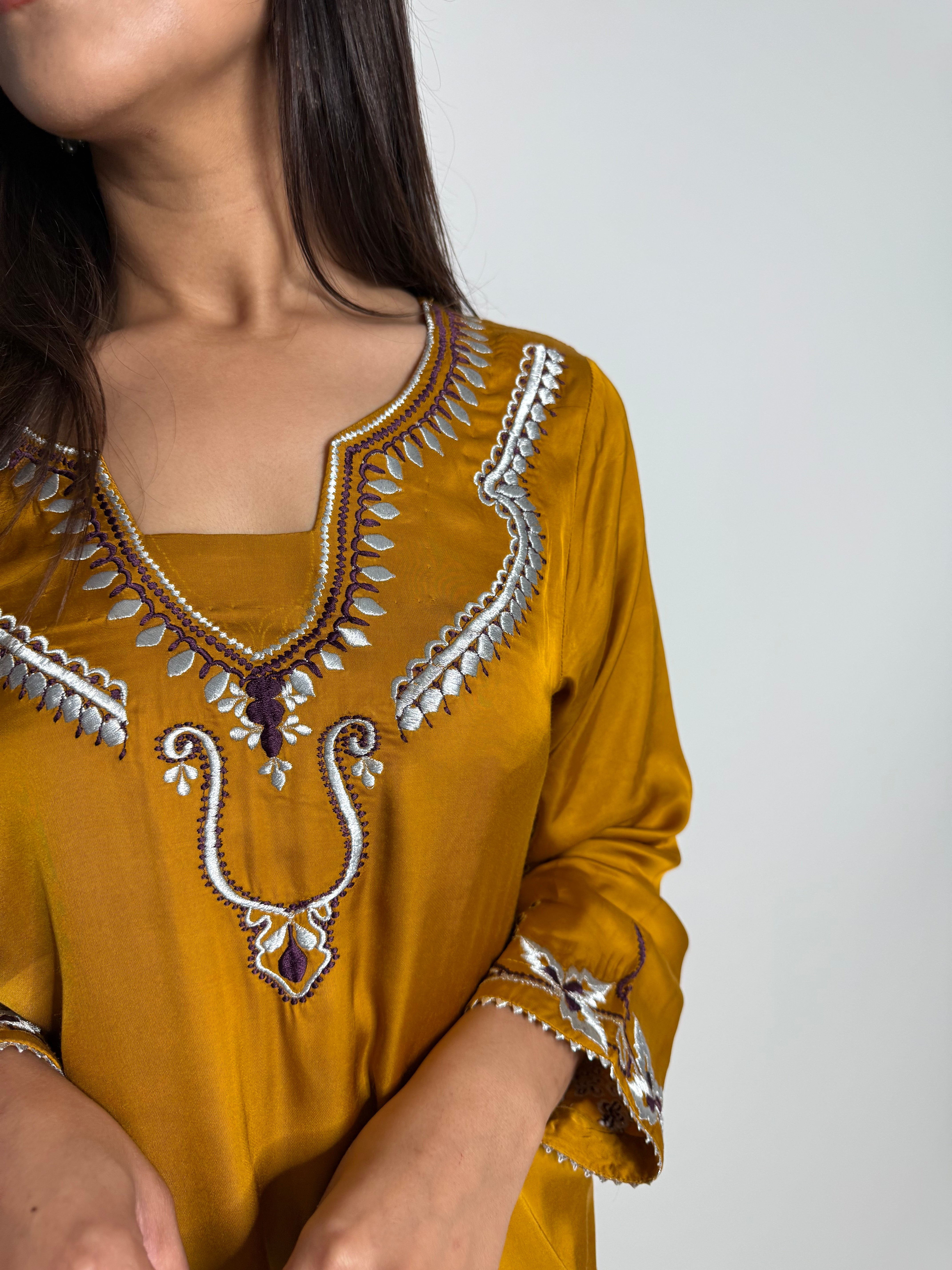 Embroidered hem detail on mustard Pakistani suit