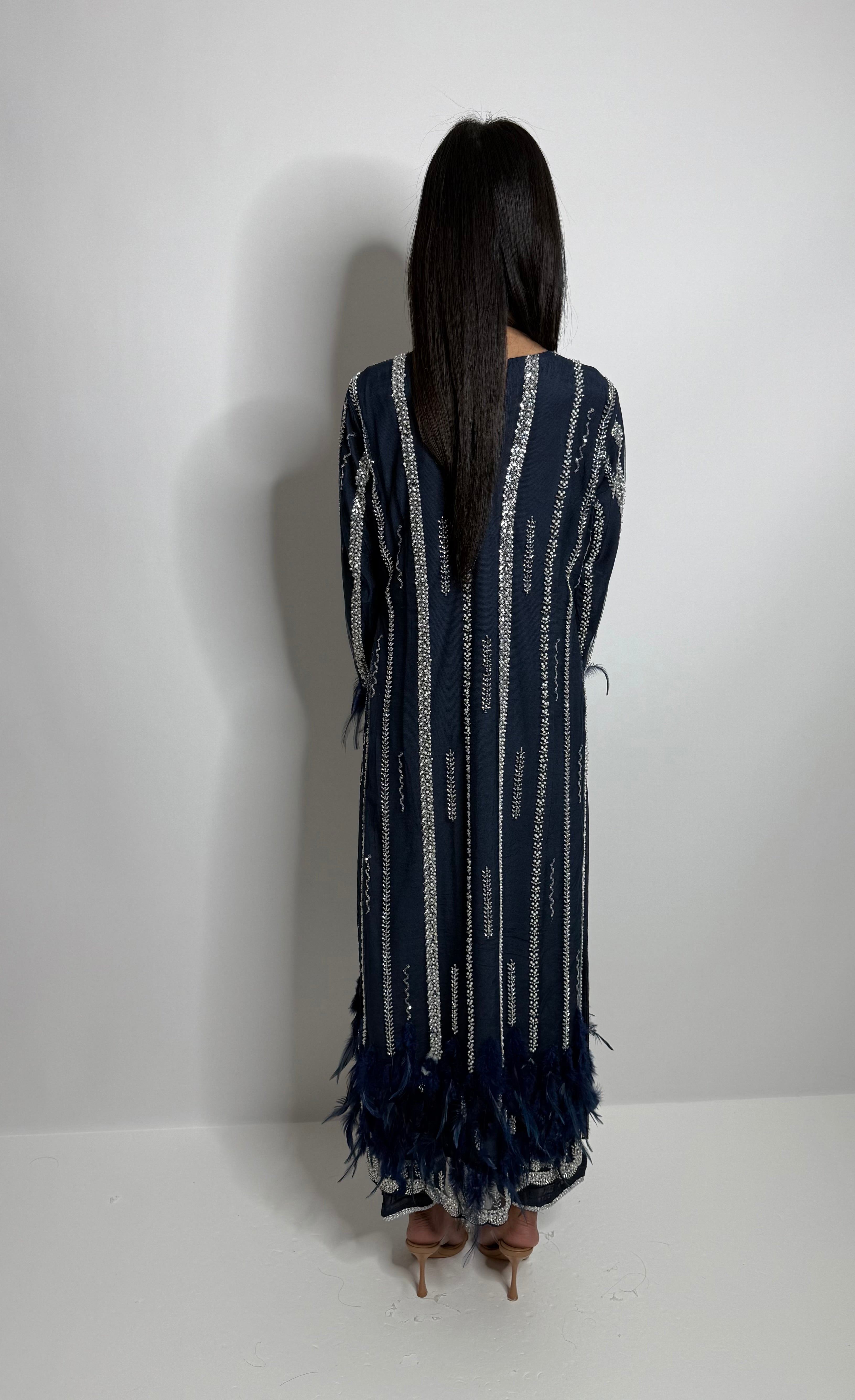 Back view of navy feather embellished kameez set with structured silhouette.