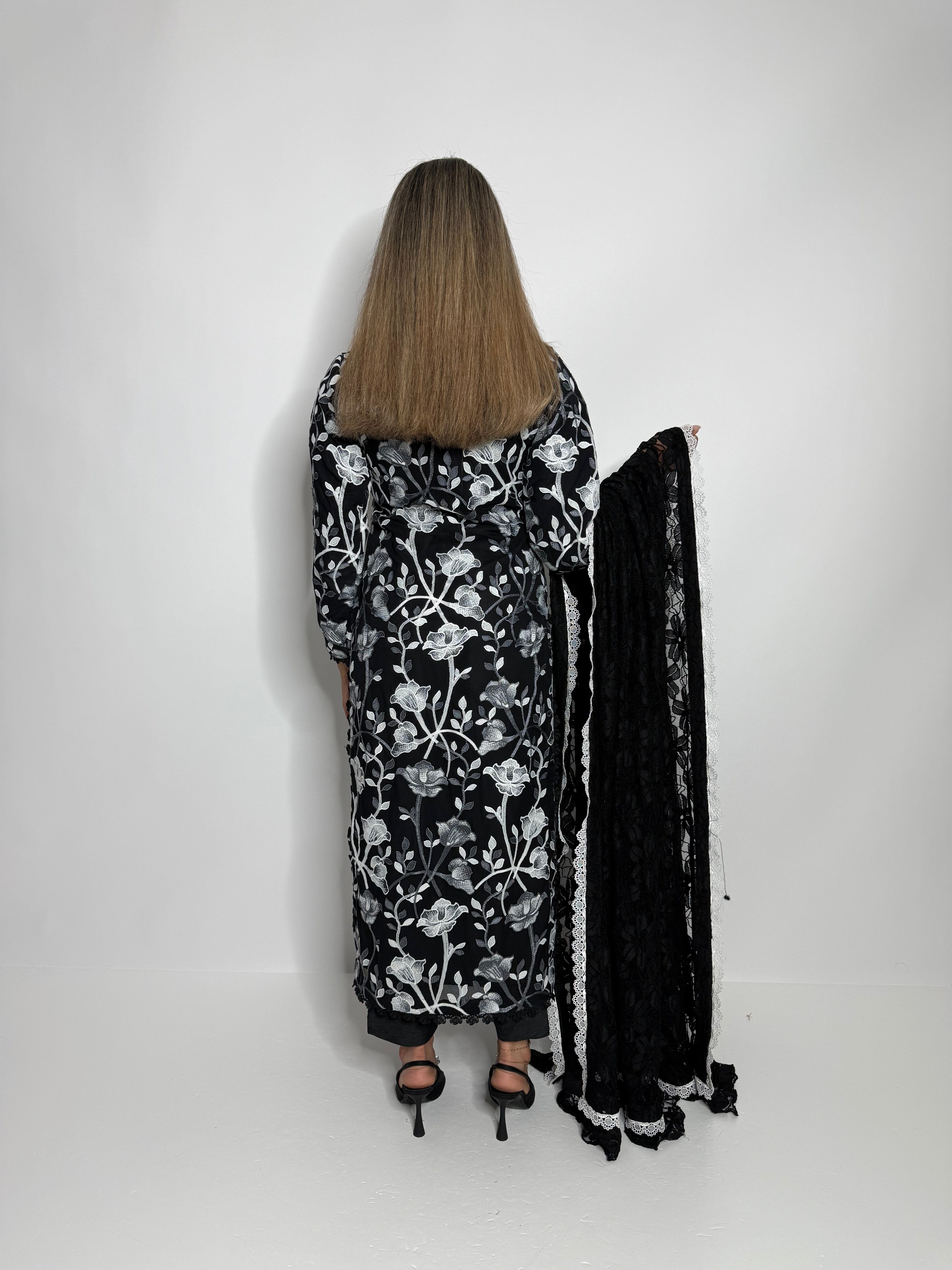 Back view of black floral net kameez set with feminine lace detailing.
